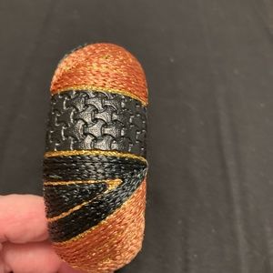 Woven black and rust colored wide bracelet. Beautiful designs.